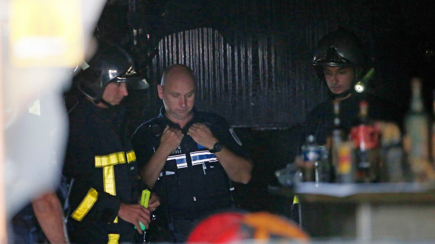 Firefighters inspect debris in the bar where a fire broke out in Rouen, France, on Saturday. Photograph: Kamil Zihnioglu/AP