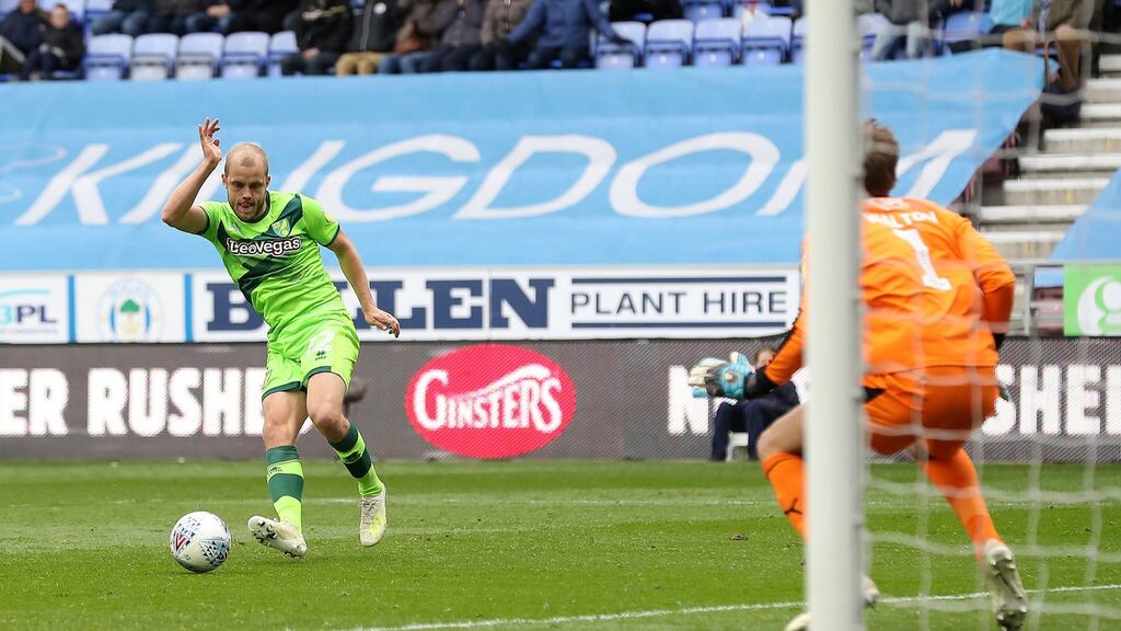 Norwich City’s Teemu Pukki scores his side’s equaliser at Wigan. Photograph: Martin Rickett/PA