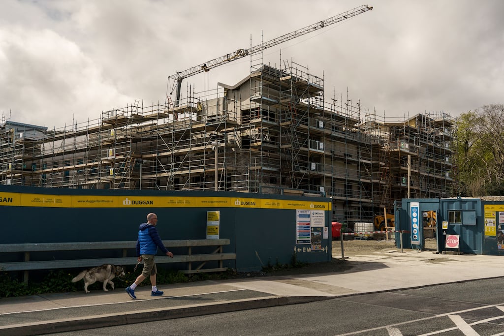 A pedestrian passes a residential construction site in the Sandyford district of Dublin, Ireland, on Monday, May 10, 2021. The mass purchase of affordable houses  on the market for about 400,000 euros ($490,000)  set off a public firestorm and highlights the growing tension over the squeeze in urban housing and the role of large investors. Photographer: Paulo Nunes dos Santos/Bloomberg