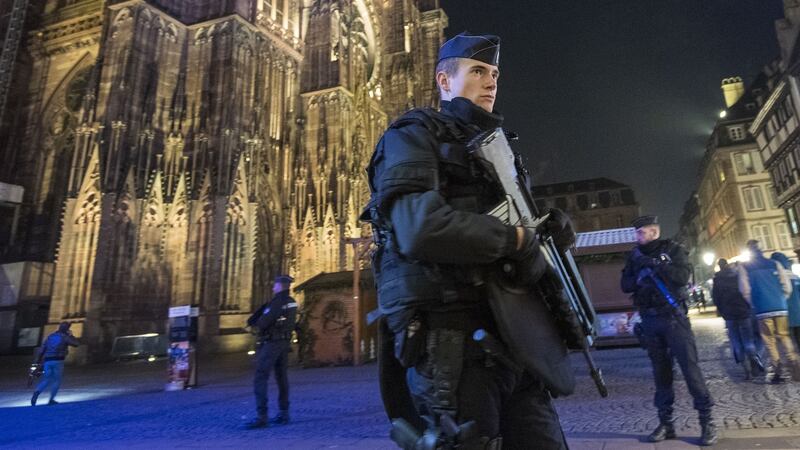Police officers patrol near the Christmas market where the day before a gunman shot 14 people, in Strasbourg, France. Photograph: Thomas Lohnes/Getty Images