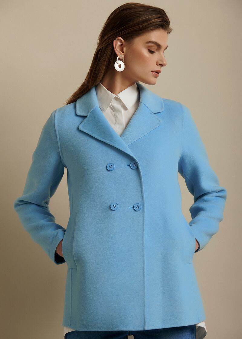 Blue double breasted coat, €224.99, by Emma Marella; blouse, €89.99, by Discord. Photograph: Alex Hutchinson