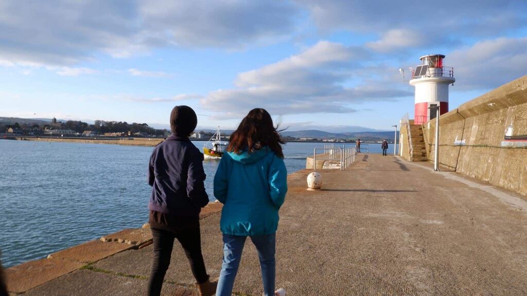 Two members of Ascend Athletics, who moved from Afghanistan to Co Wicklow after the Taliban took over the country, taking a walk by the sea at Wicklow harbour: ‘I’ve never seen the sea before I came to Ireland.’ Photograph: Jade Wilson