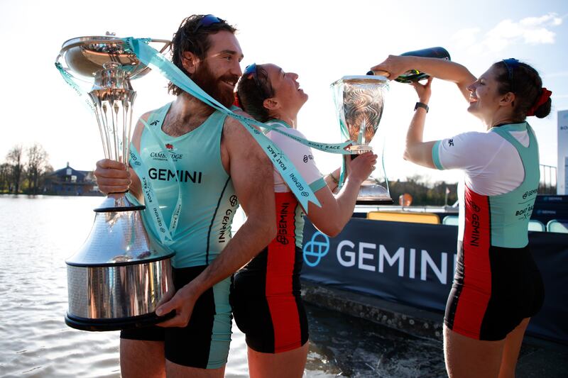 Cambridge captains Sebastian Benzecry and Jenna Armstrong, centre, celebrate after their teams' victories in the annual Boat Race on the River Thames, London. Photograph: David Cliff/EPA/EFE
