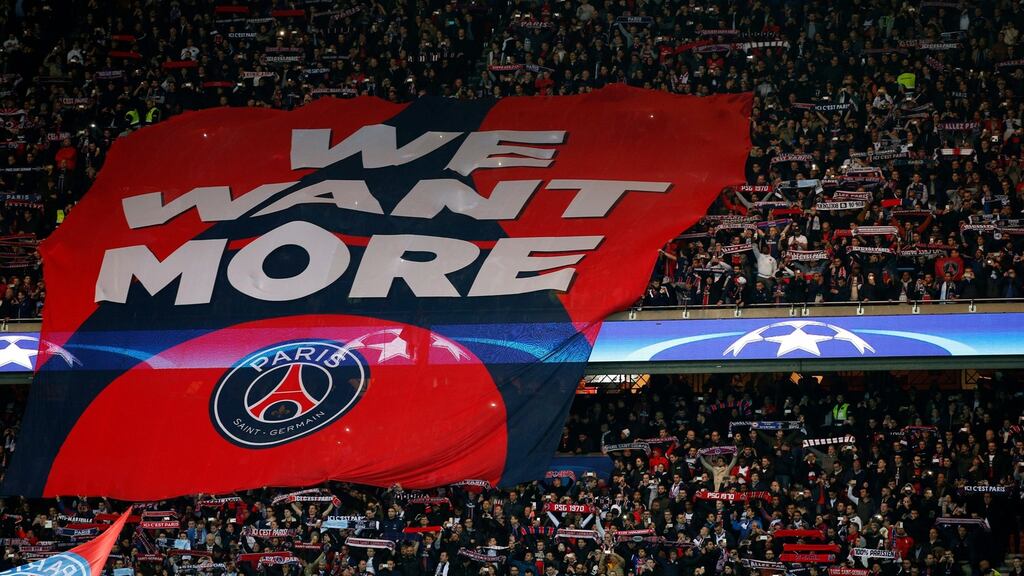 Paris Saint Germain fans hold aloft a banner before their side’s clash with Manchester City in the Champions League at the Parcs des Princes Stadium. Photo: Yoan Valat/EPA