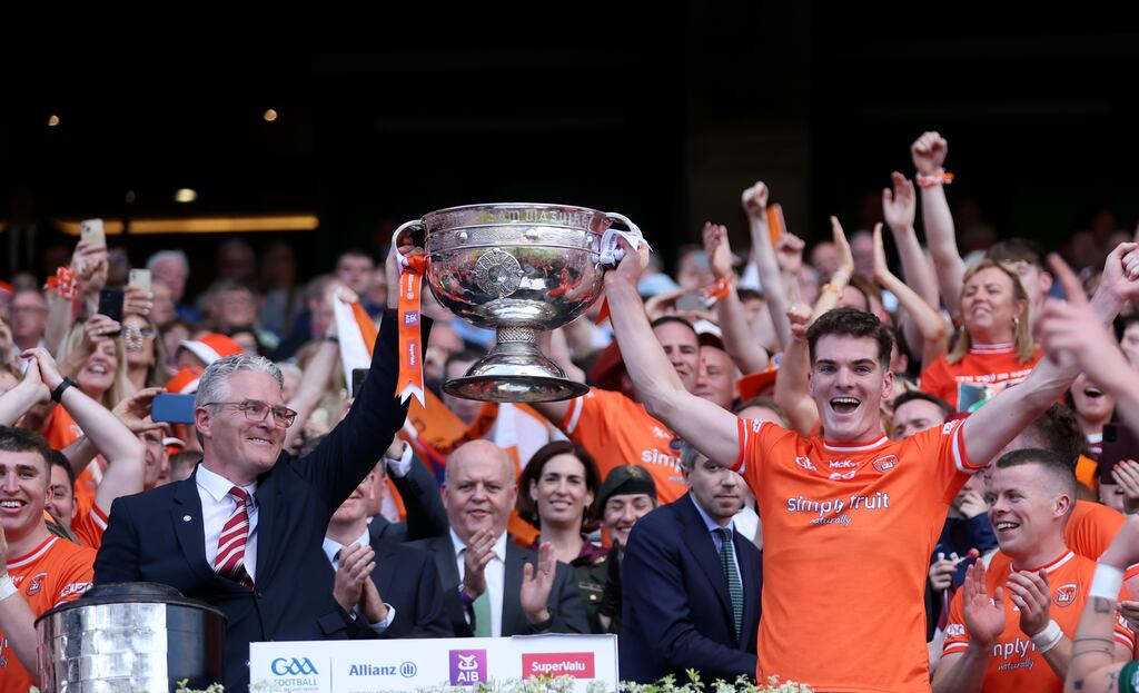 GAA president Jarlath Burns and his son Jarly Óg Burns lifing the Sam Maguire cup in July 2024 after beating Galway. Photograph: James Crombie/Inpho