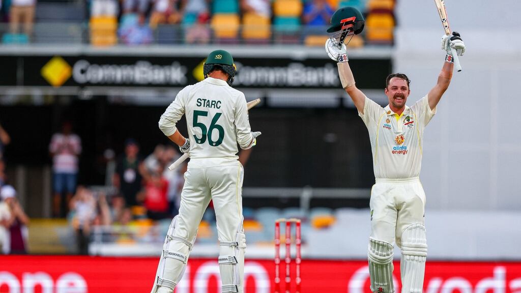 Travis Head celebrates his century with teammate Mitchell Starc during day two of the first Ashes Test match. Photo: Patrick Hamilton/Getty Images