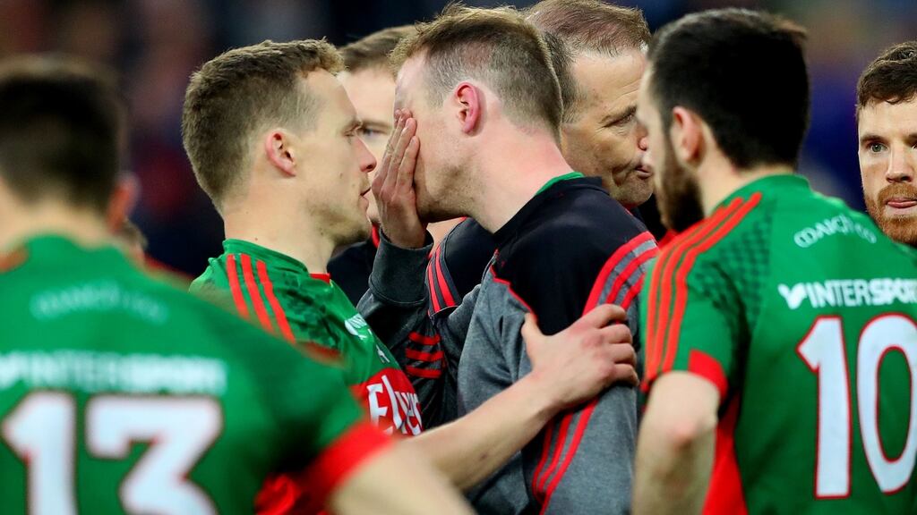 Robert Hennelly consoled by Andy Moran after the game. Photograph: James Crombie/INPHO