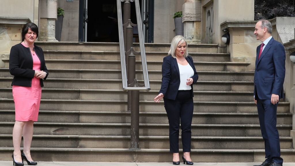 Taoiseach Micheál Martin with First Minister Arlene Foster and Deputy First Minister Michelle O’Neill at Stormont: “I want to work out in practical terms how we share this island together over the next while and beyond.” Photograph: Brian Lawless/PA
