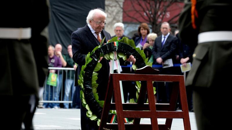 President Micheal D Higgins lays a wreath outside the GPO on O’Connell Street in Dublin as part of the Easter Sunday commemoration ceremony. Photograph: Cyril Byrne