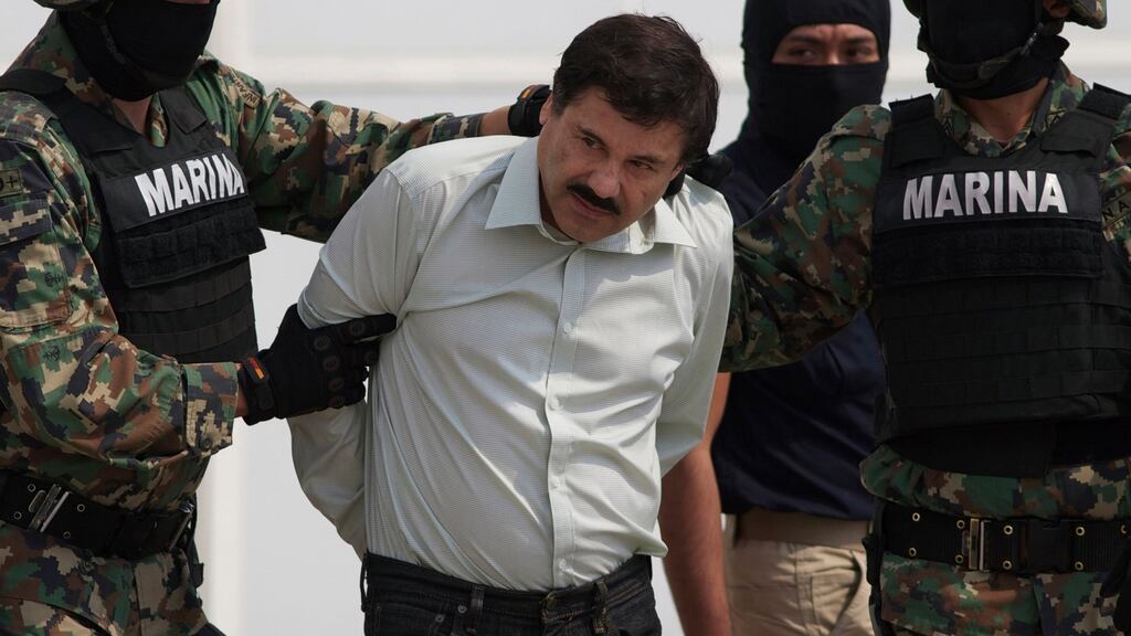 In this , 2014 file photo, Joaquin “El Chapo” Guzman is escorted to a helicopter in handcuffs by Mexican navy marines at a navy hanger in Mexico City, Mexico. Photograph: Eduardo Verdugo, File/AP