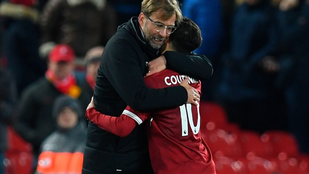 Liverpool’s German manager Jurgen Klopp hugs Philippe Coutinho after the Swansea win. Photograph: Getty Images