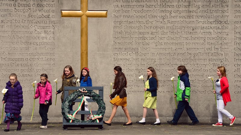 Children lay 16 lilies at the annual Fianna Fáil 1916 commemoration in Arbour Hill, Dublin. Photograph: Eric Luke