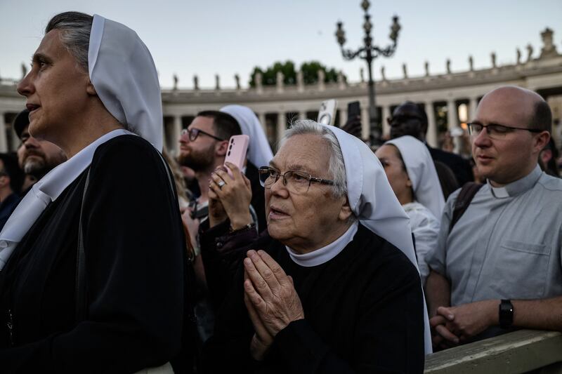 People in St Peter's Square watch as the newly elected Pope Leo XIV makes his first appearance in the main central loggia balcony of St Peter's Basilica on Thursday. Photograph: Jeff Pachoud/AFP via Getty Images