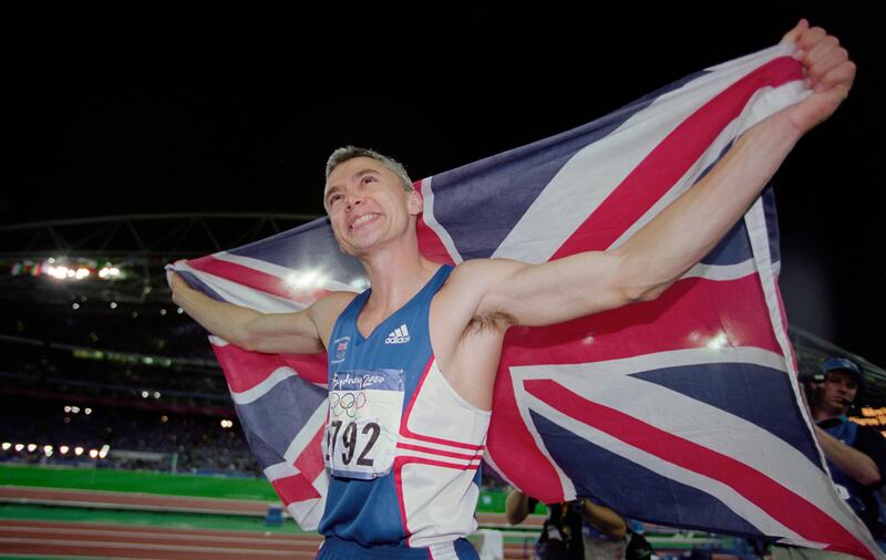 Jonathan Edwards celebrates after winning gold in the Men's Triple Jump final at the 2000 Olympic Games in Sydney. Photograph: Stu Forster/Allsport/Hulton Archive/Getty Images