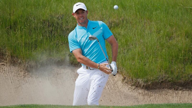 McIlroy splashes a bunker shot out at the 16th. Photo: Gregory Shamus/Getty Images