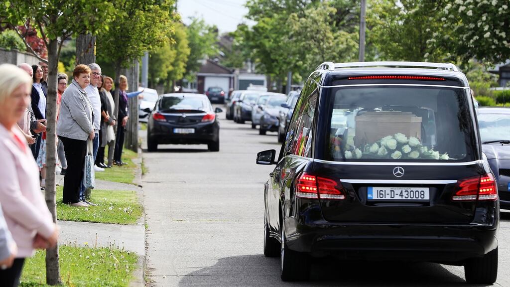 Friends and neighbours of the late Frank McDonald gather outside their homes on Grove Park Avenue in Dublin earlier this month as his funeral cortege passed  down the street wherehe lived for  60 years. Photograph:  Brian Lawless/PA Wire