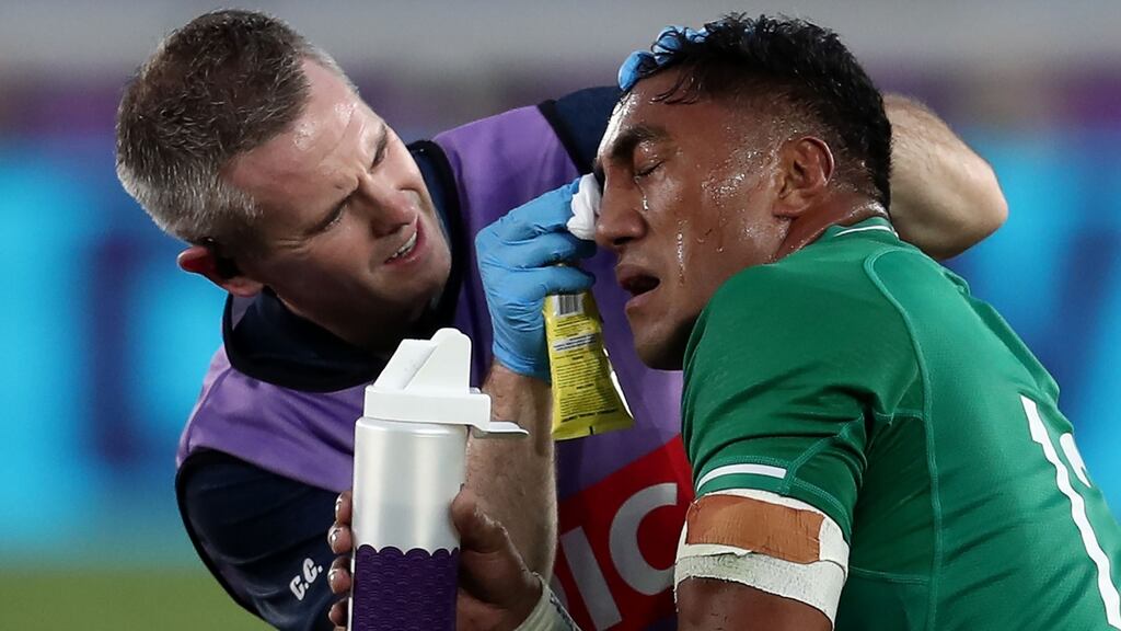 Bundee Aki receives medical attention during the Pool A match at the International Stadium in Yokohama. Photograph: Behrouz Mehri/AFP/Getty Images