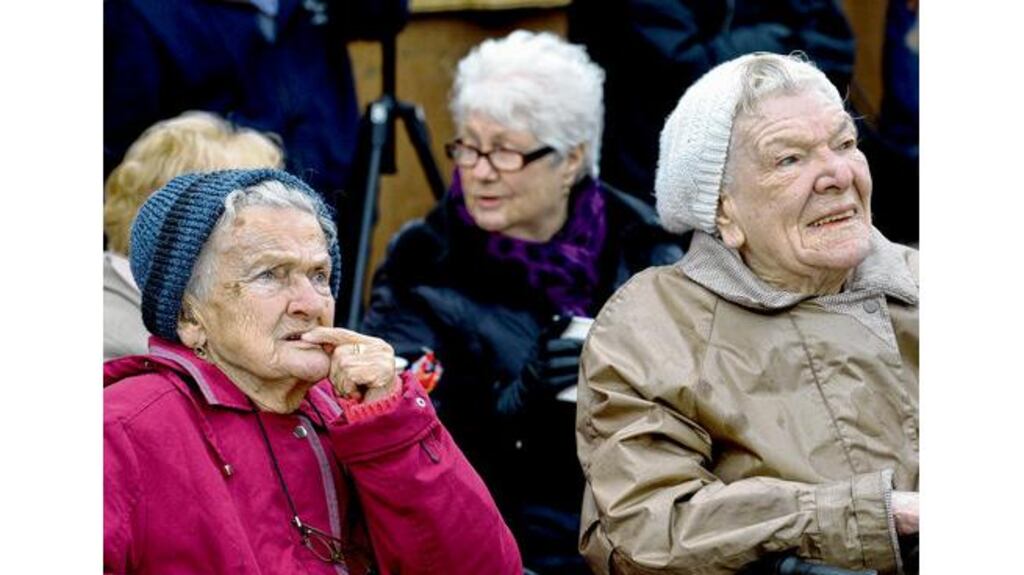 Patricia Moles and Bridget Murphy watch demolition begin on the final tower block at St Michael's Estate, Inchicore, Dublin, yesterday. photograph: dara mac dónaill