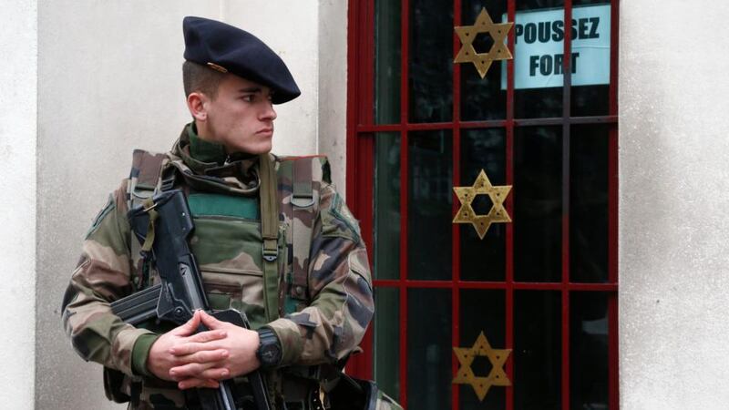 A French soldier secures the access to a Jewish institution in Neuilly-sur-Seine in western Paris yesterday, as part of the highest level of the “Vigipirate” security plan after last week’s terrorist attacks. Photograph: Charles Platiau/Reuters