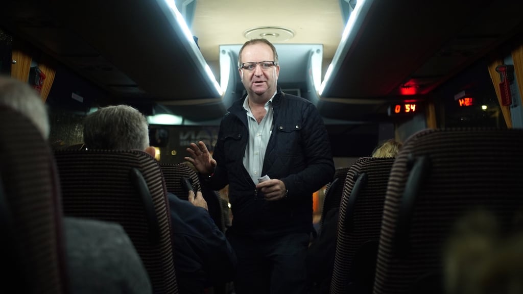 Cork South-West TD Michael Collins speaks to passengers on a bus bringing people to Belfast for cataract operations. Photograph: Enda O’Dowd