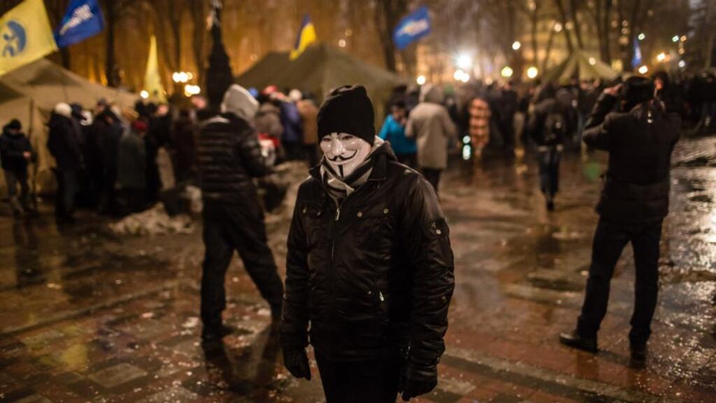 A man in a Guy Fawkes mask attends a rally held by the pro-government Party of Regions in support of Ukrainian President Viktor Yanukovych on Thursday in Kiev, Ukraine. Photograph: Getty