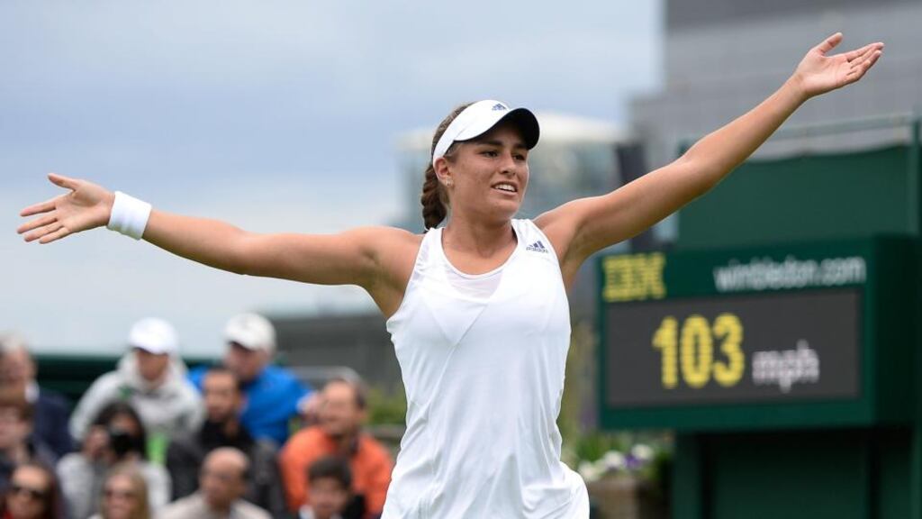 Monica Puig of Puerto Rico celebrates match point during her Ladies’ Singles first round match against Sara Errani of Italy on day one of Wimbledon. Photograph: Dennis Grombkowski/Getty Image