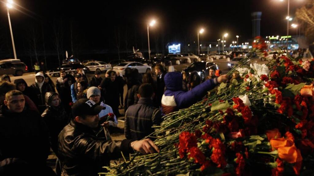 People lay flowers near a fence of Kazan airport, where a Tatarstan Airlines Boeing 737-500 airliner crashed. Photograph: Maxim Shemetov /Reuters