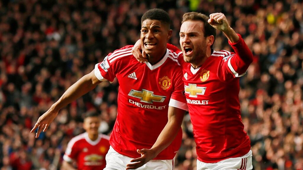 Marcus Rashford and Juan Mata celebrate during Manchester United’s 3-2 win over Arsenal at Old Trafford. Photograph: Reuters