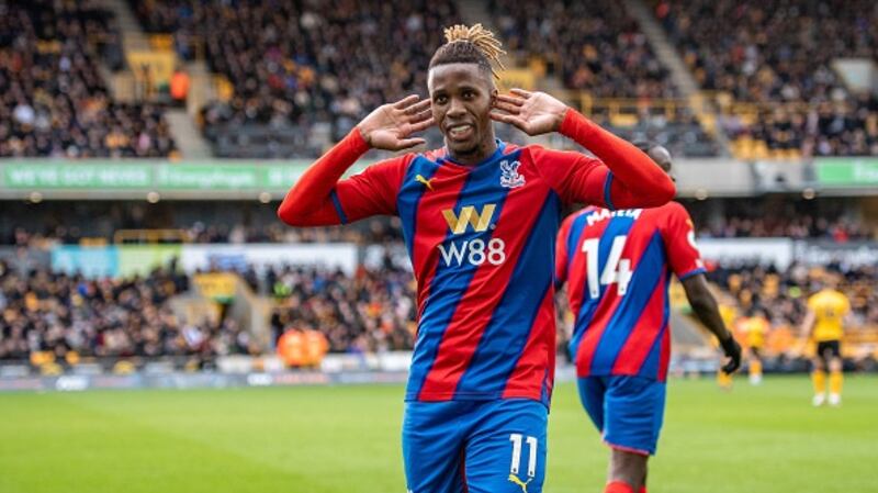Wilfried Zaha celebrates after scoring his penalty. Photograph: Sebastian Frej/MB Media/Getty Images