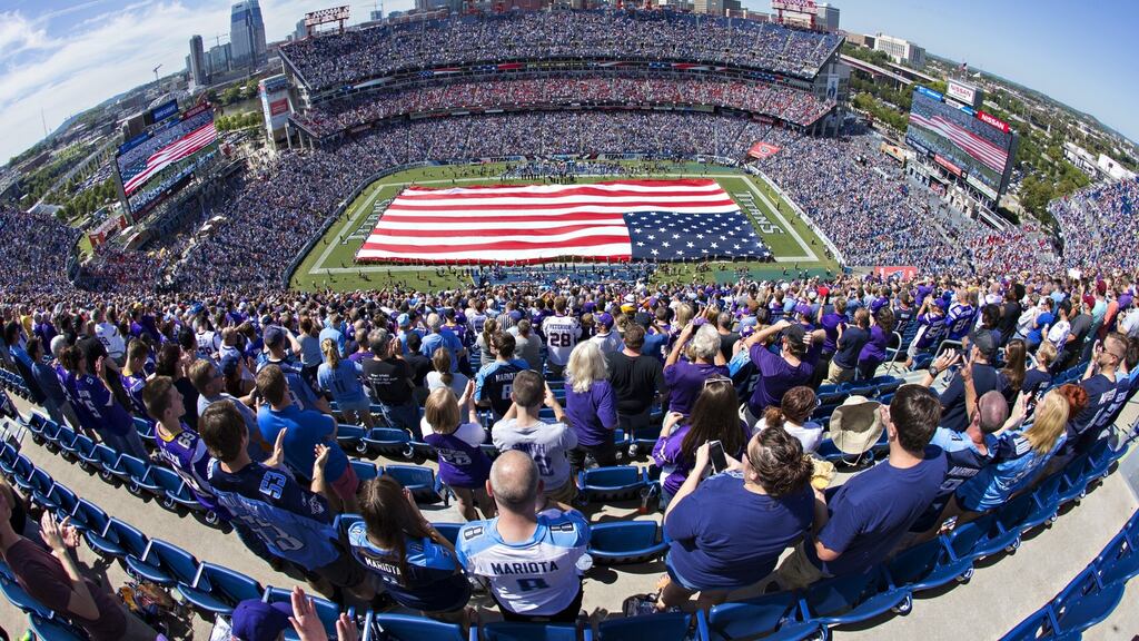 The United States flag covering the field before the game between the Tennessee Titans and the Minnesota Vikings at the brand new Nissan Stadium in Nashville, Tennessee. The Vikings defeated the Titans 25-16. Photo: Wesley Hitt/Getty Images