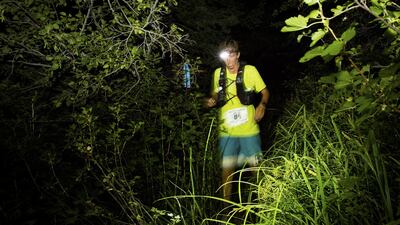 Courtney Dewaulter races through the night about 60 miles into the Tahoe 200 ultramarathon in Incline Village, Nevada.
