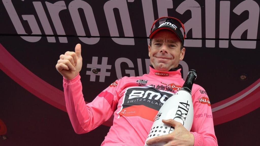 Australian rider Cadel Evans of the BMC Racing team celebrates on the podium after taking the overall leader’s pink jersey following the eighth stage of the Giro d’Italia.