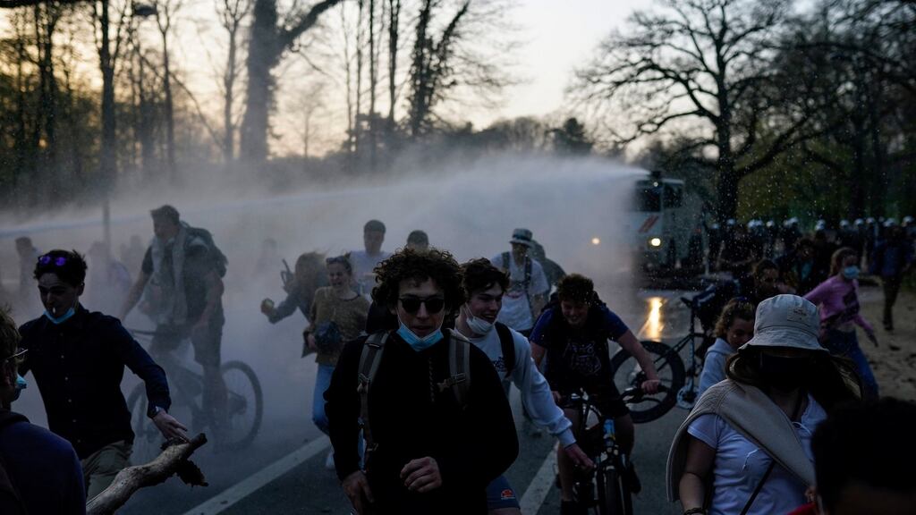 Young people are sprayed by a police water cannon during clashes  in the Bois de la Cambre park in Brussels, Thursday. Photograph: AP Photo/Francisco Seco