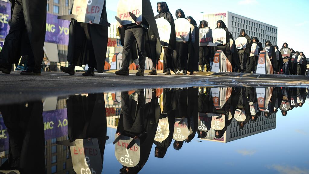 Protesters are seen carrying gravestones with the numbers of Cop conferences claiming they have failed during a protest in Glasgow. Photograph: Peter Summers/Getty Images