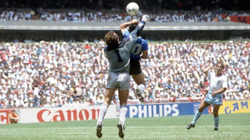 The 1986 World Cup quarter final. Argentina’s Diego Maradona scores his side’s first goal past English goalkeeper Peter Shilton by use of his hand. Maradona later claimed that the goal was scored by “The hand of God”. Photograph: Bob Thomas/Getty Images