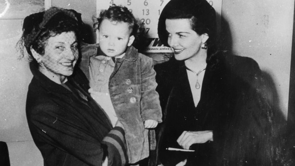 Jane Russell (right) with  Irish-born infant  Thomas Kavanagh at New York airport. The boy was taken to Russell by his mother, who pleaded with the Hollywood star  to take him to the US. Photograph: Keystone/Getty Images.