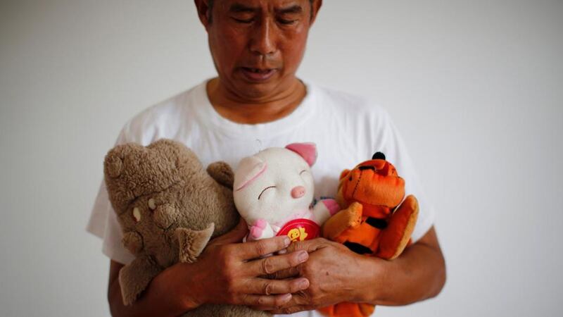 Zhang Yongli, whose daughter Zhang Qi was on board Malaysian Airlines Flight MH370 looks at his daughter’s soft toys. Photograph: Reuters