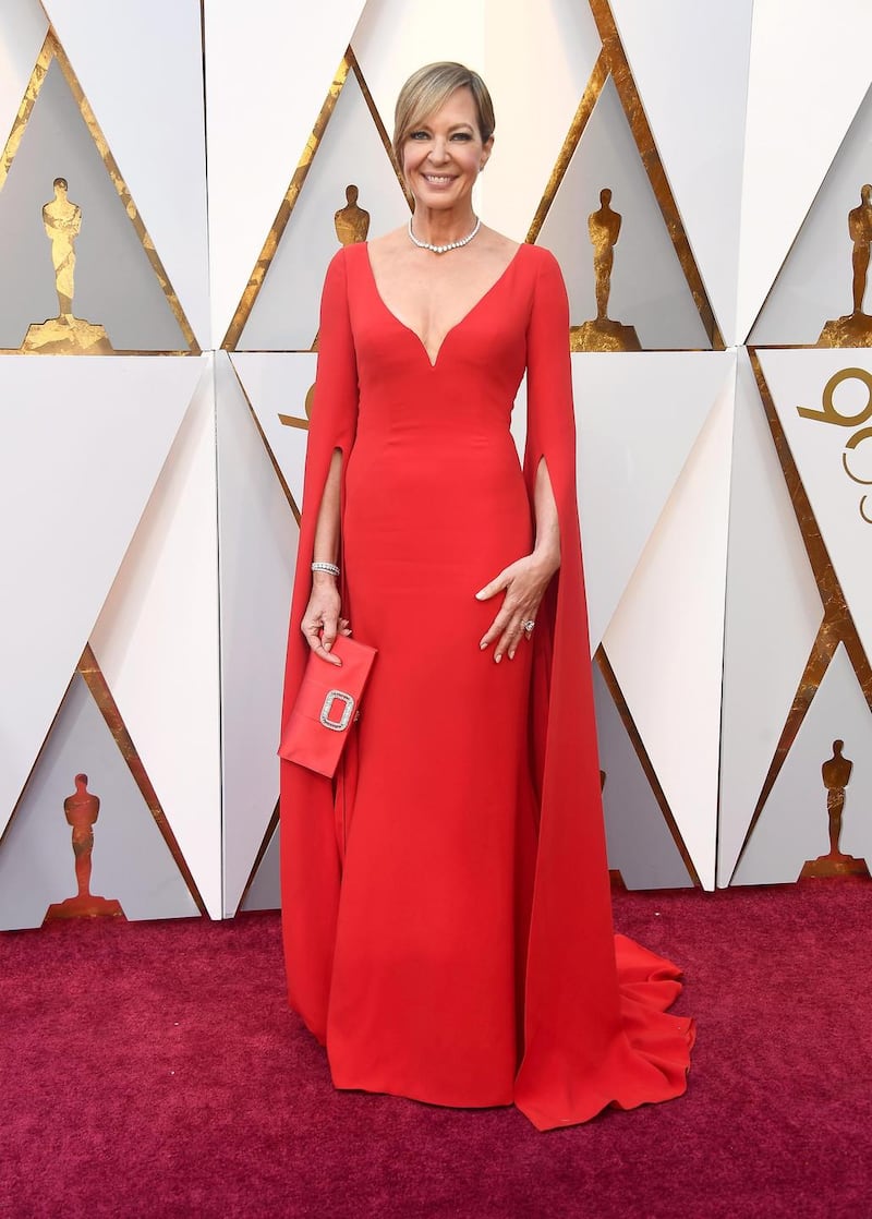 Allison Janney wore a vibrant rouge Reem Acra dress with plunging décolletage and cape sleeves