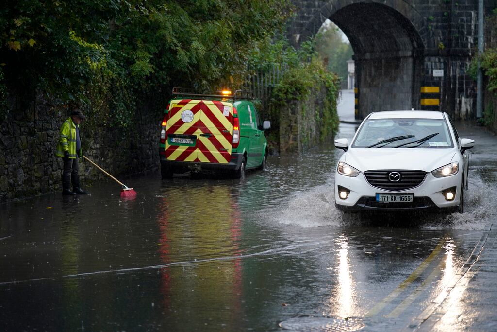 A local authority worker clears a road gully in Co Kilkenny following Storm Babet earlier this month. Photograph: Niall Carson/PA Wire