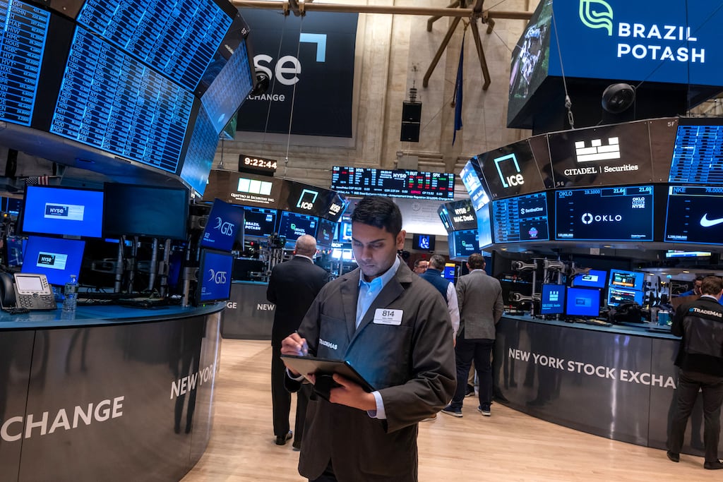 Traders work on the New York Stock Exchange floor on Wednesday. The Dow was up almost 200 points in morning trading before the Federal Reserve meeting on interest rates. Photograph: Spencer Platt/Getty Images