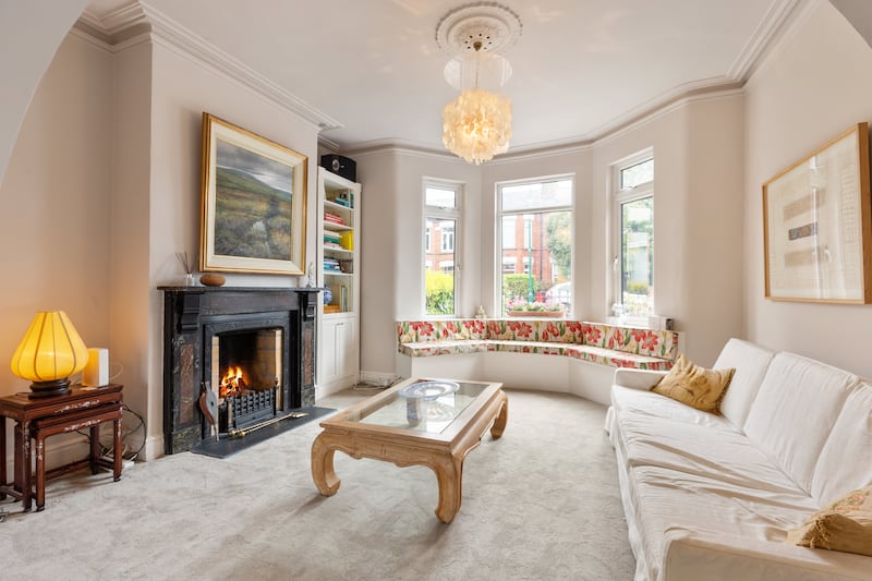 Front reception room has a period fireplace and a bay window. Photographs: Viv van der Holst