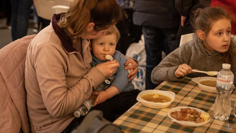A woman feeds her baby in a reception tent after arriving at an evacuation point in Zaporizhzhia for people fleeing the Azovstal plant, Mariupol. Photograph: Chris McGrath/Getty Images