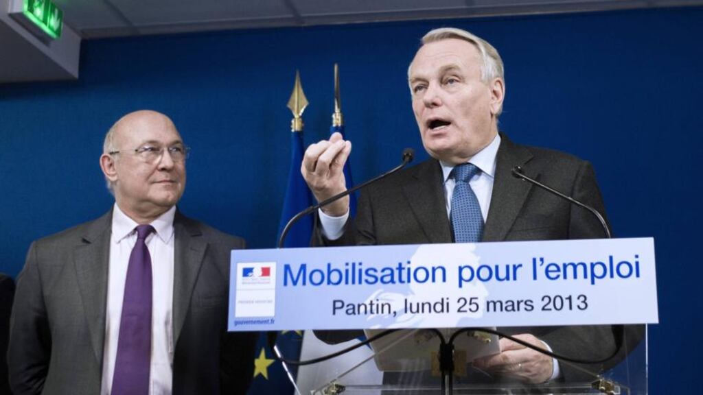 French prime minister Jean-Marc Ayrault delivers a speech next to labour minister Michel Sapin in Pantin, a Paris suburb, on Monday. Photograph: Fred Dufour/Reuters