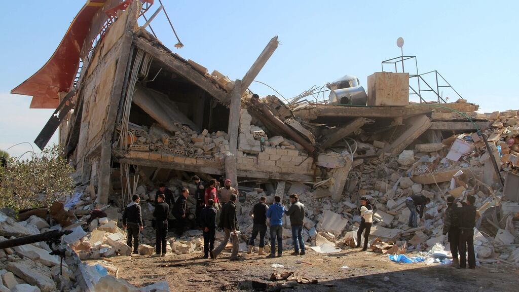 People gather around the rubble of a hospital supported by Doctors Without Borders (MSF) near Maaret al-Numan, in Syria’s northern province of Idlib, on Monday, after the building was hit by suspected Russian air strikes. Photograph: AFP/Getty Images