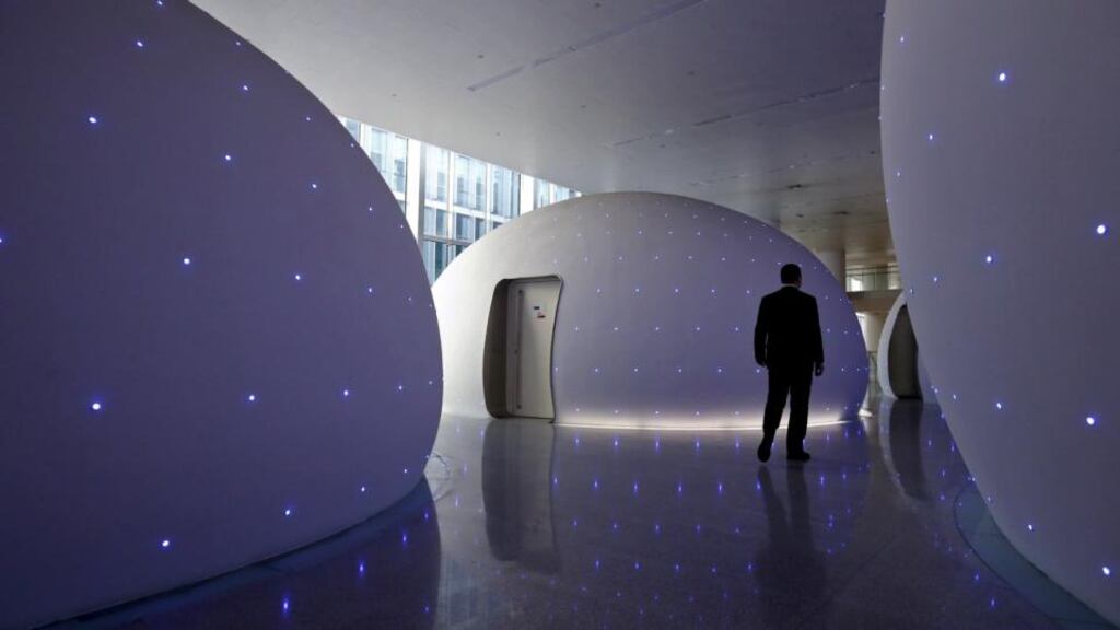 A man walks past sleeping rooms for employees at Baidu’s headquarters in Beijing. Baidu’s shares were down 8.17 per cent at $181.50 in trading after the bell