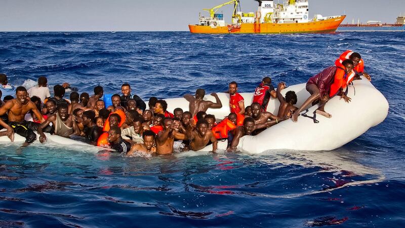 Migrants on a dinghy are approached by the Aquarius off the coast of the Italian island of Lampedusa. Photograph: Patrick Bar/SOS Mediterranee via AP