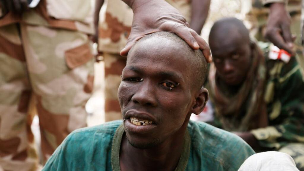 People at a Nigerian market clubbed to death a teenage girl suspected of being a suicide bomber. Above, a man, whom the Chadian military say they have taken prisoner for belonging to insurgent group Boko Haram. Niger, Cameroon and Chad have launched a regional military campaign to help Nigeria defeat the Boko Haram insurgency. Photograph: Emmanuel Braun/Reuters