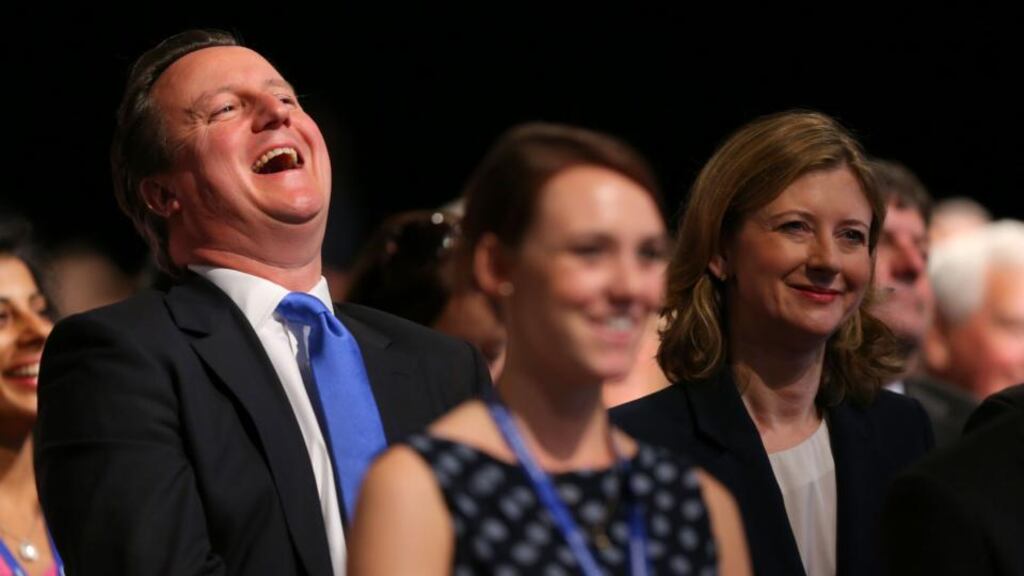 Prime Minister David Cameron enjoying the keynote speech on the second day of the Conservative Party Conference in Manchester, with Frances Osborne (right) the wife of chancellor of the exchequer George Osborne. Photograph: Dave Thompson/PA Wire
