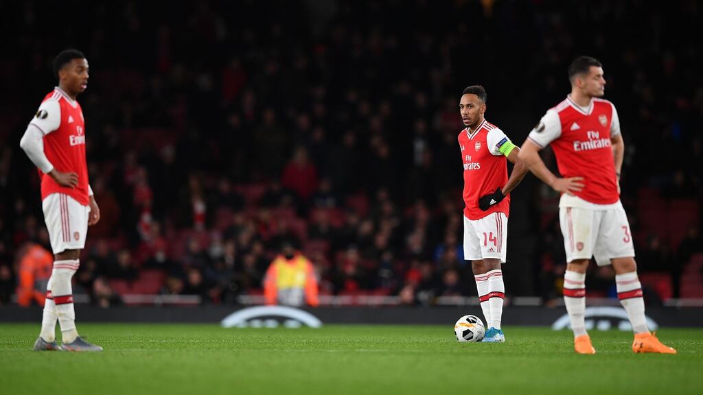 Arsenal’s striker Pierre-Emerick Aubameyang and teammates react after Frankfurt’s Daichi Kamada scored his team’s second goal. Photograph: Getty Images