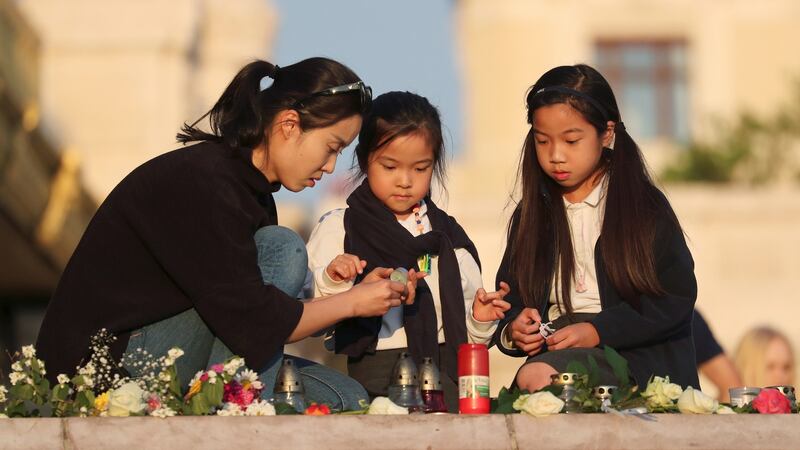 People light candles at a memorial to the dead after a capsize incident, near Margaret Bridge in Budapest, Hungary. Photograph: Marko Djurica/Reuters